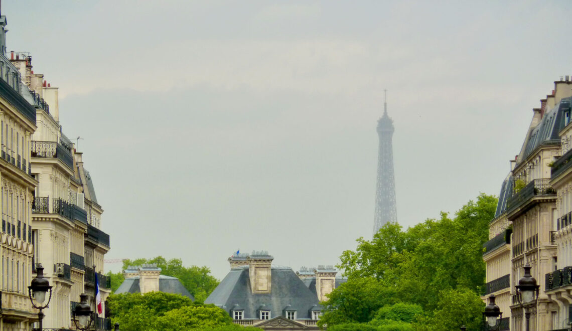 view of a street in Paris with Eiffel Tower on the background