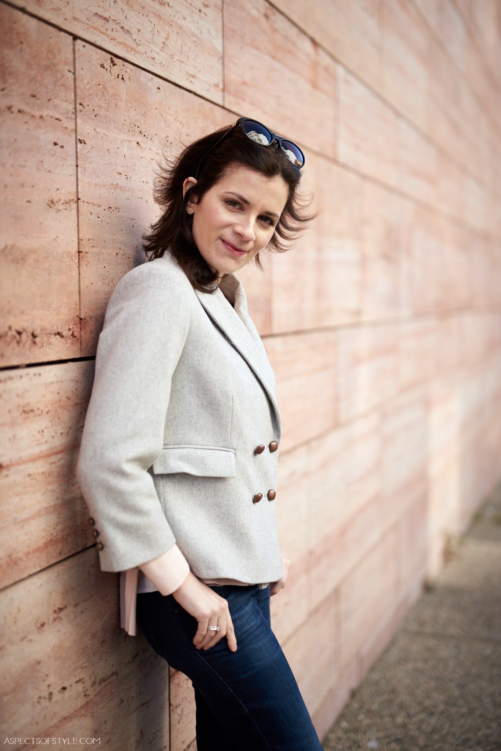 Grey cropped jacket and blue jeans