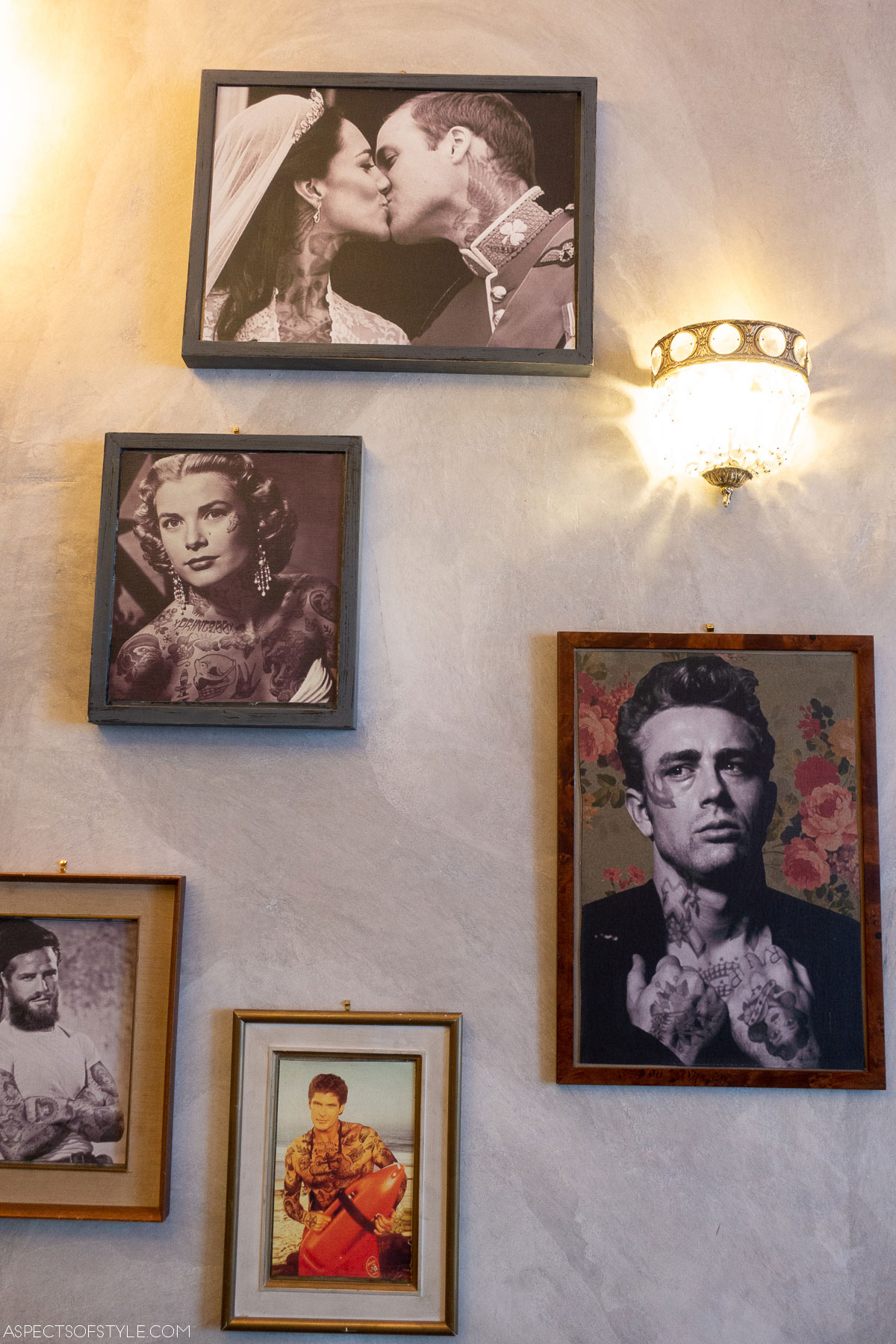 two tables with chairs and portraits on the wall