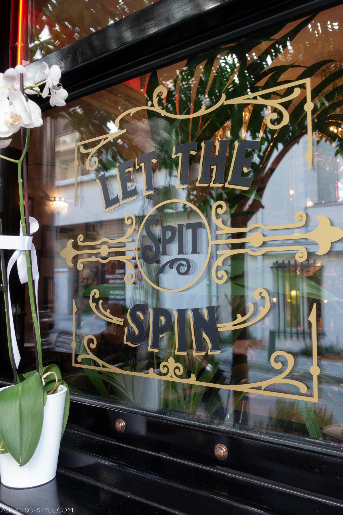 Window with letters saying let the spit spin