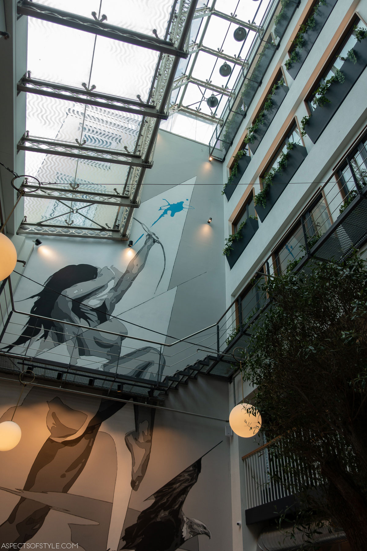 Ergon House atrium with mural depicting woman with arrow